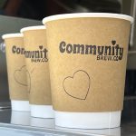 Three cardboard recyclable coffee cups branded with a rubber stamped logo